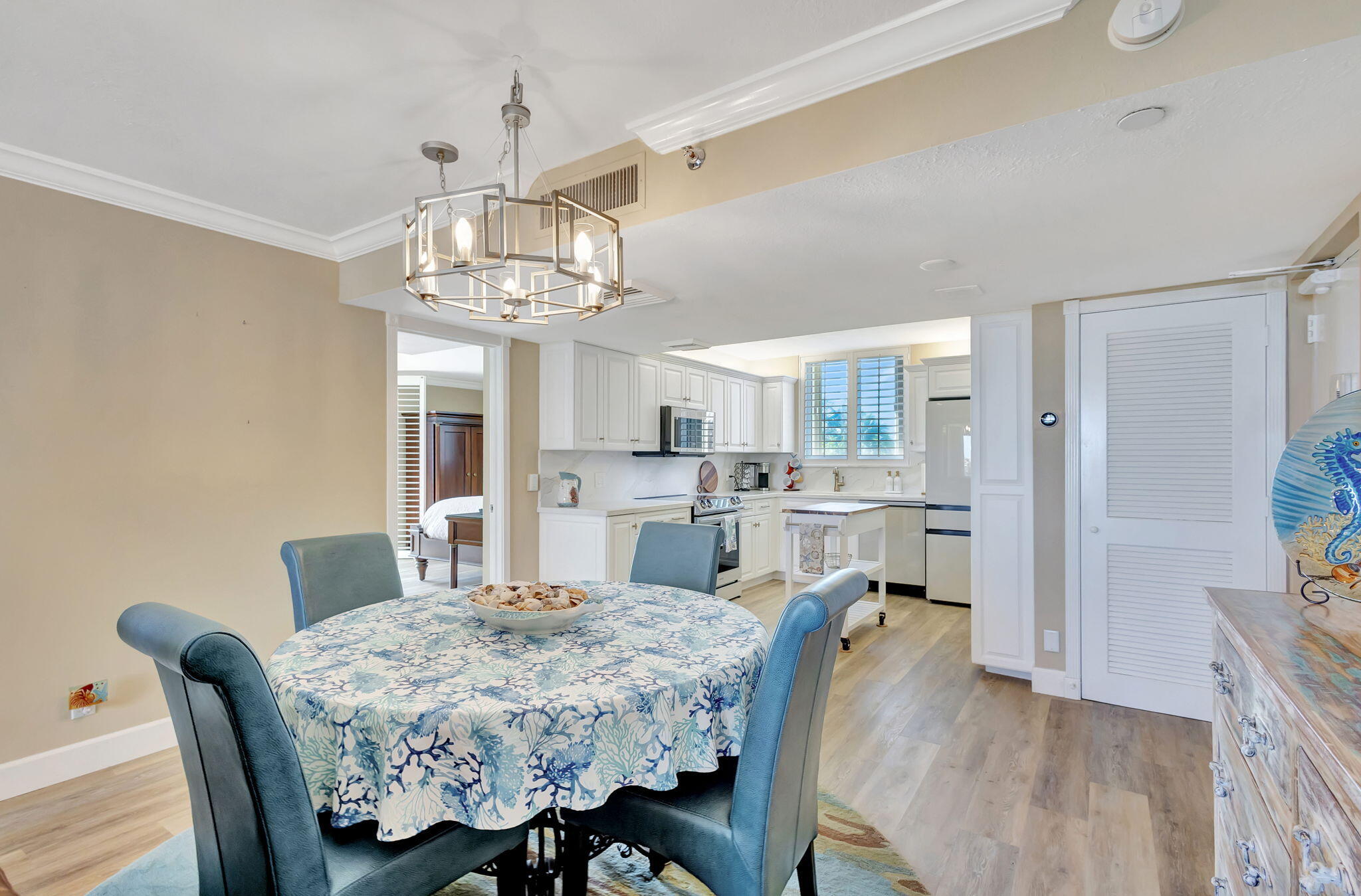 100 Ocean Trail Way, Unit 301 Jupiter, FL 33477 - Photo 11 of 67 a view of a dining room with furniture and wooden floor