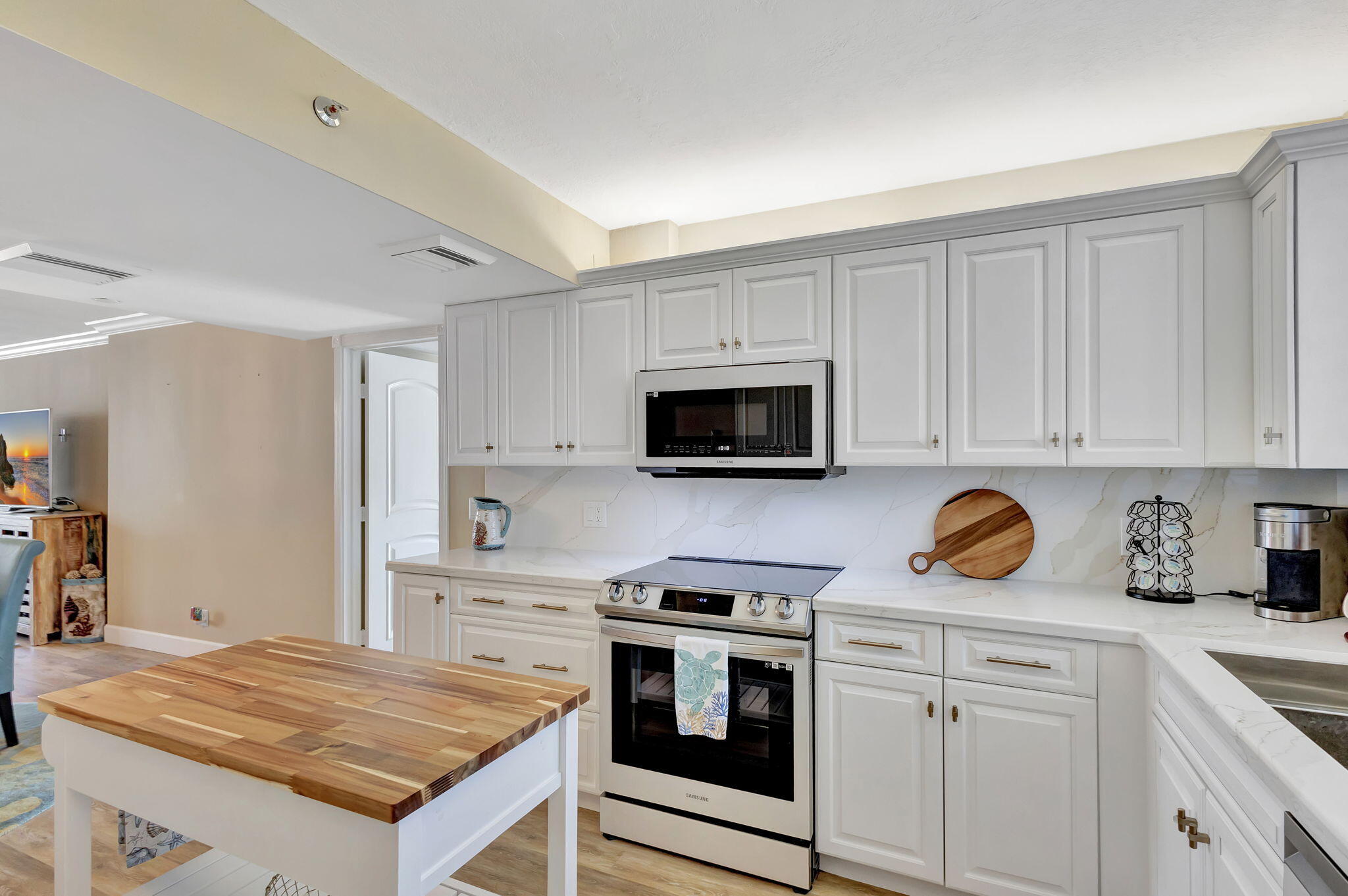 100 Ocean Trail Way, Unit 301 Jupiter, FL 33477 - Photo 3 of 67 a kitchen with stainless steel appliances granite countertop a sink stove and microwave