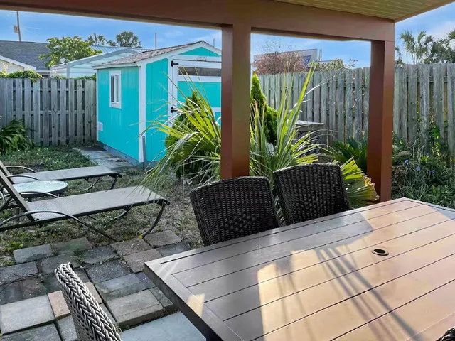 a wooden bench sitting in front of a building