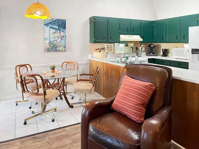 a kitchen that has a table and chairs in it