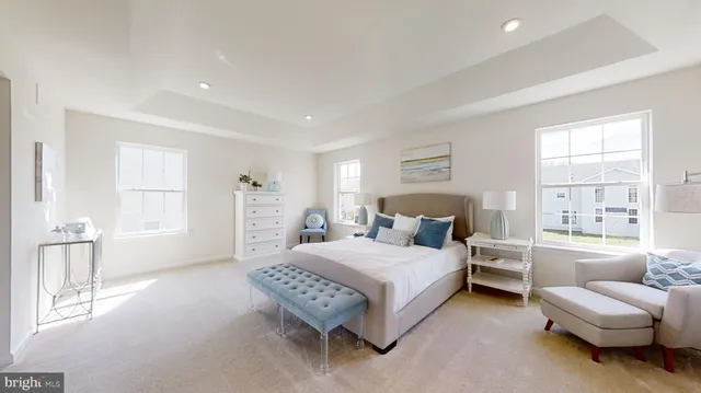 a bedroom with a bed couch and a window