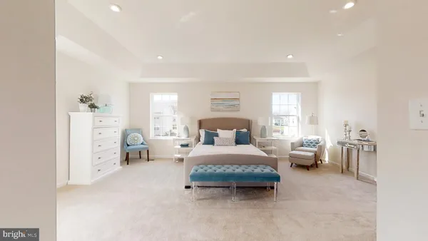 a spacious bedroom with a bed and a large window