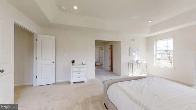 a spacious bedroom with a bed and a window