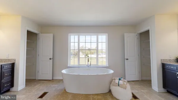 a view of an empty room with a window and fireplace