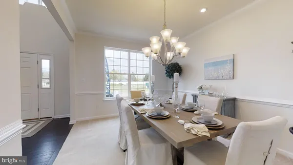 a view of a dining room with furniture wooden floor and chandelier