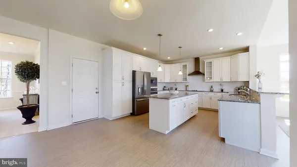a kitchen with white cabinets and counter space