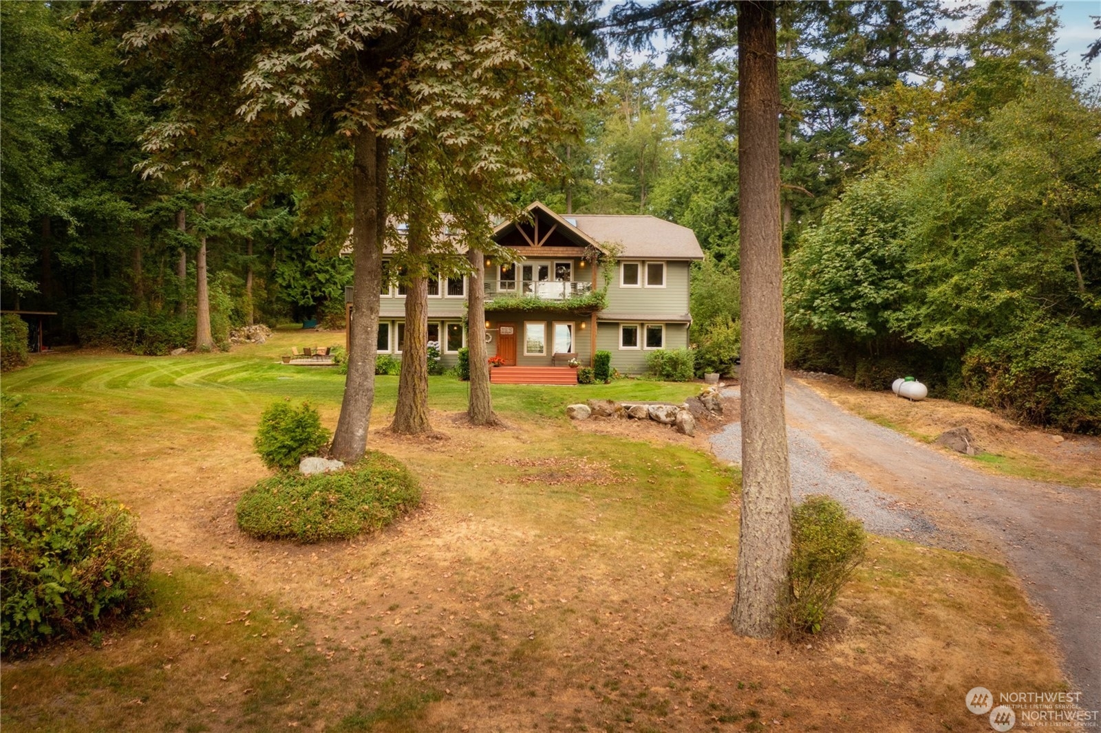 2170 Hilltop Road Lummi Island, WA 98262 - Photo 5 of 31 a backyard of a house with a yard and outdoor seating