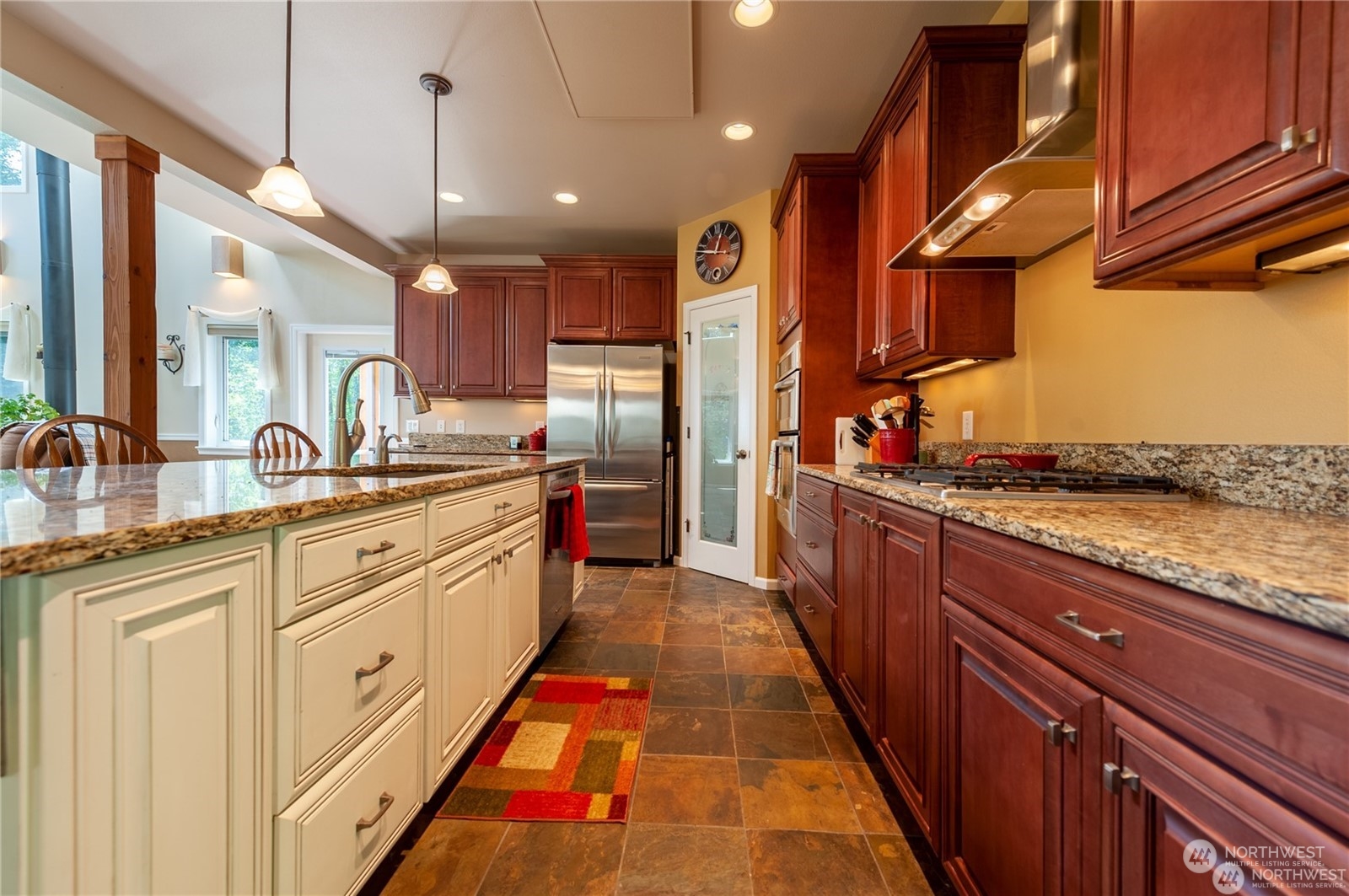 2170 Hilltop Road Lummi Island, WA 98262 - Photo 7 of 31 a large kitchen with stainless steel appliances kitchen island granite countertop a sink and cabinets