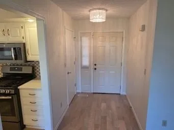 a view of a kitchen from the hallway