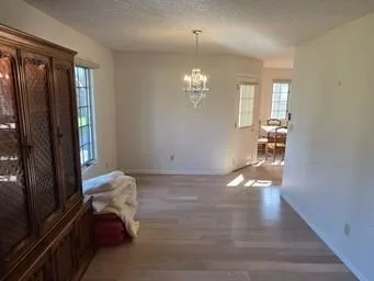 a view of entryway with livingroom and chandelier