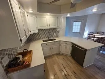 a kitchen with a sink stove and cabinets
