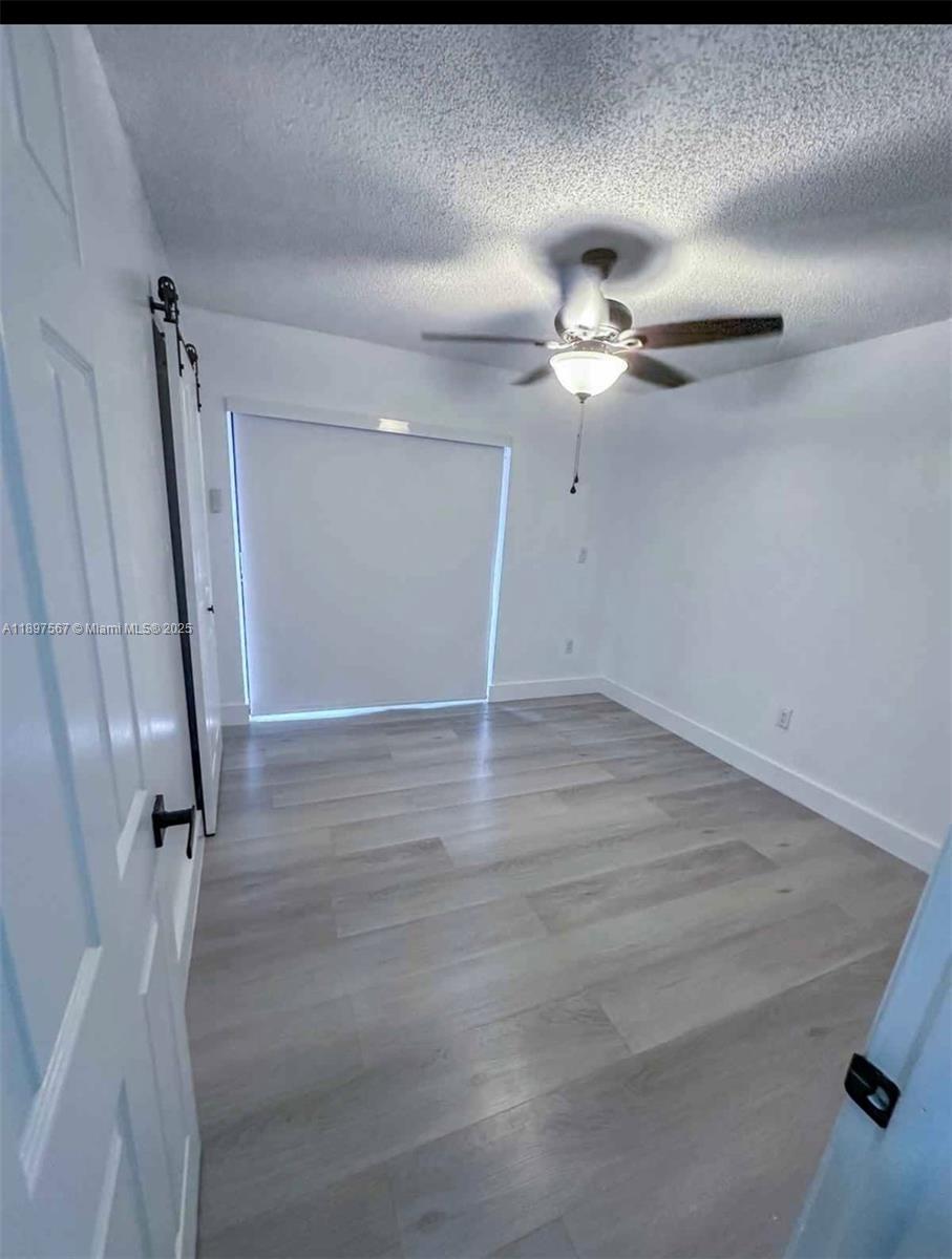 2301 West 60th Street, Unit A211 Hialeah, FL 33016 - Photo 18 of 29 wooden floor in an empty room