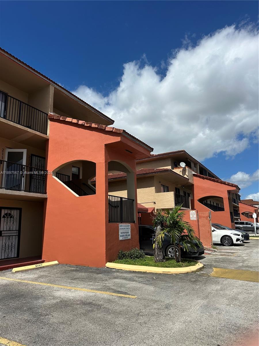 2301 West 60th Street, Unit A211 Hialeah, FL 33016 - Photo 2 of 29 a front view of a house with a garden