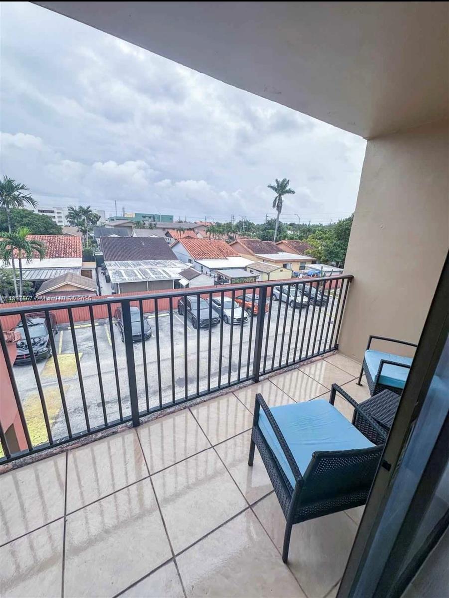 2301 West 60th Street, Unit A211 Hialeah, FL 33016 - Photo 21 of 29 a view of a balcony with wooden benches