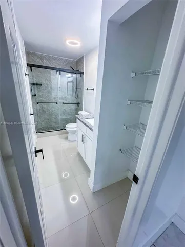 a bathroom with a sink and glass door shower