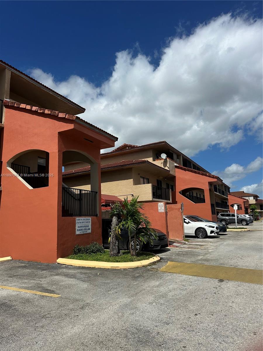 2301 West 60th Street, Unit A211 Hialeah, FL 33016 - Photo 3 of 29 a front view of a house with a yard