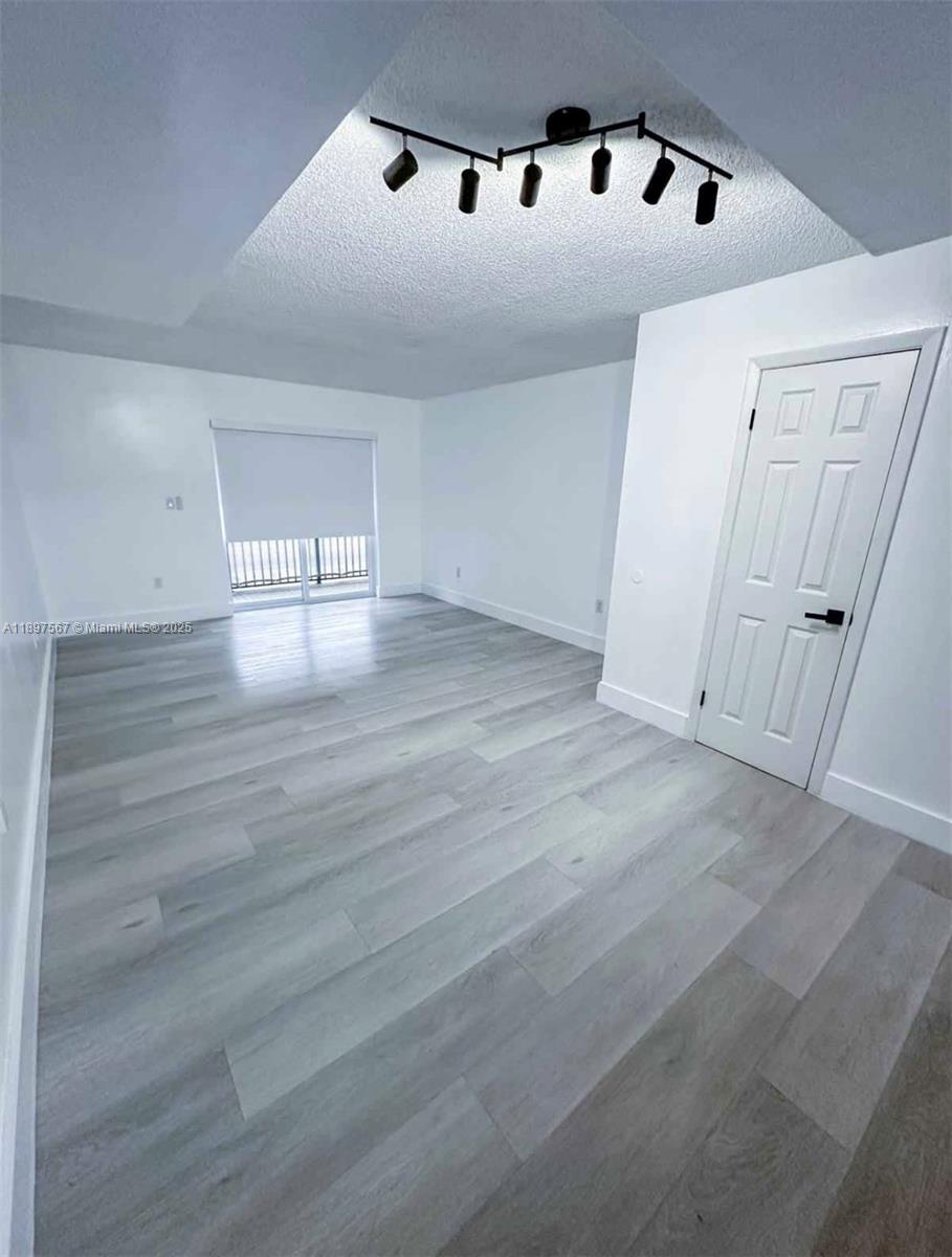 2301 West 60th Street, Unit A211 Hialeah, FL 33016 - Photo 6 of 29 a view of an empty room with window