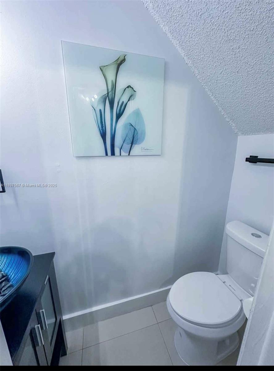2301 West 60th Street, Unit A211 Hialeah, FL 33016 - Photo 8 of 29 a white toilet sitting next to a shower