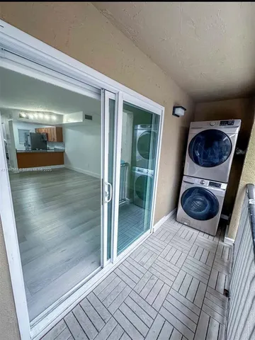 a room with a bed and glass door
