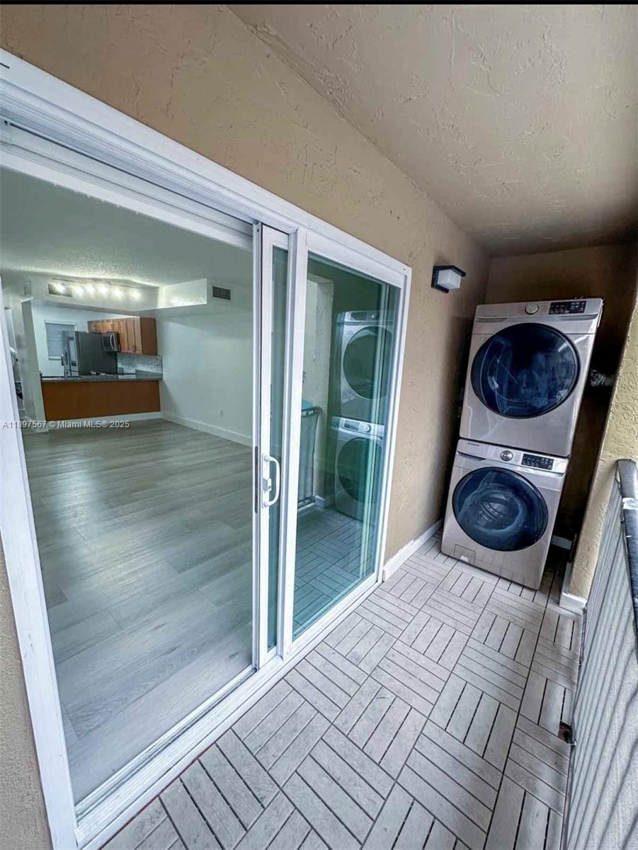 2301 West 60th Street, Unit A211 Hialeah, FL 33016 - Photo 9 of 29 a room with a bed and glass door