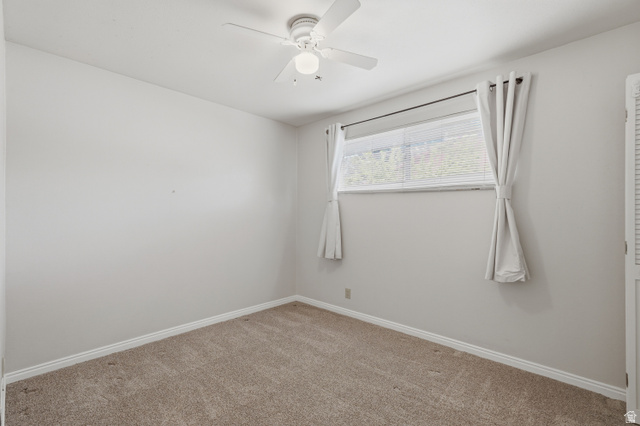 378 West 200 South Bountiful, UT 84010 - Photo 15 of 32 Neutral-toned room featuring light beige carpeting, white baseboards, and a window with white blinds and drapes