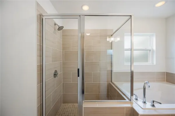 a bathroom with a bathtub and a shower