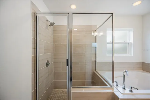 a bathroom with a bathtub and a shower