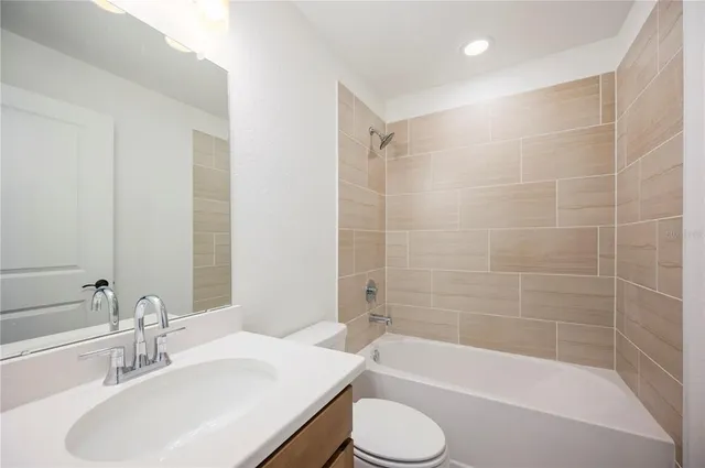 a bathroom with a sink a toilet and bathtub