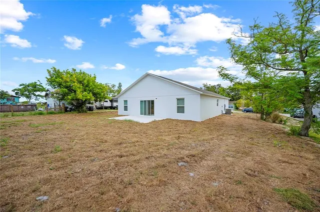 a view of a house with a backyard
