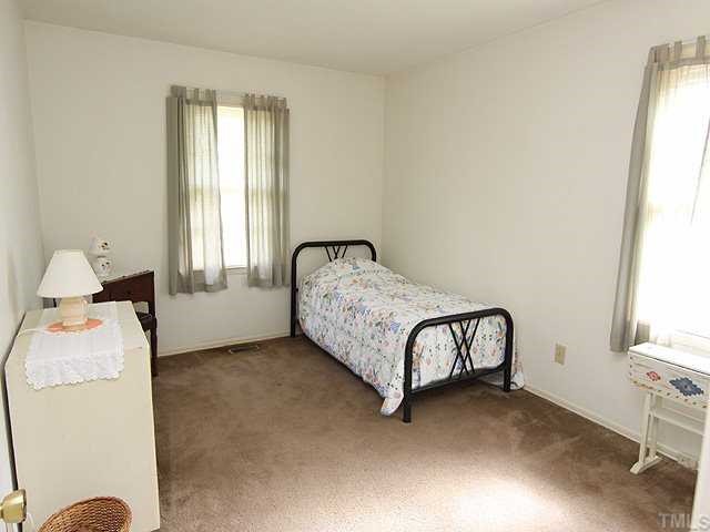 3525 Morningside Drive Raleigh, NC 27607 - Photo 8 of 12 a bedroom with a bed and window