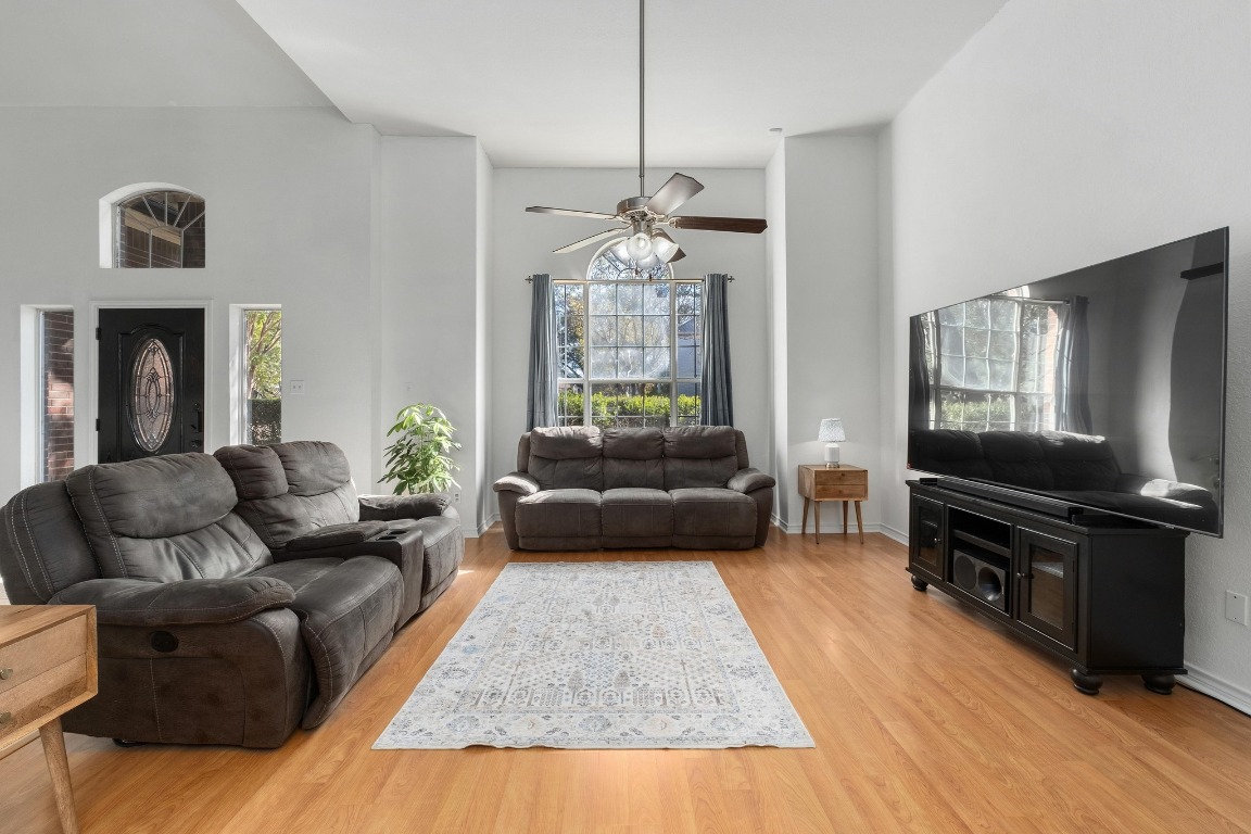 3808 Latimer Drive Austin, TX 78732 - Photo 14 of 31 a living room with furniture fireplace and a flat screen tv