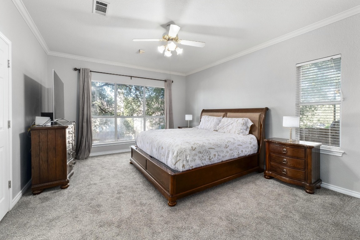 3808 Latimer Drive Austin, TX 78732 - Photo 16 of 31 a spacious bedroom with a bed and a flat tv screen on dresser