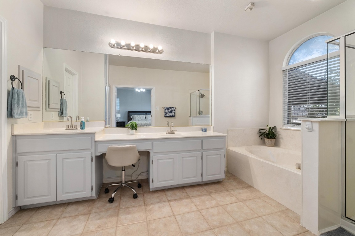 3808 Latimer Drive Austin, TX 78732 - Photo 19 of 31 a bathroom with a sink a tub and a mirror