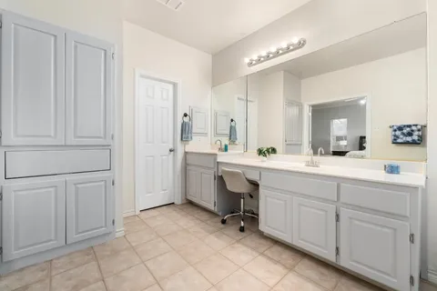 a bathroom with a tub sink and mirror