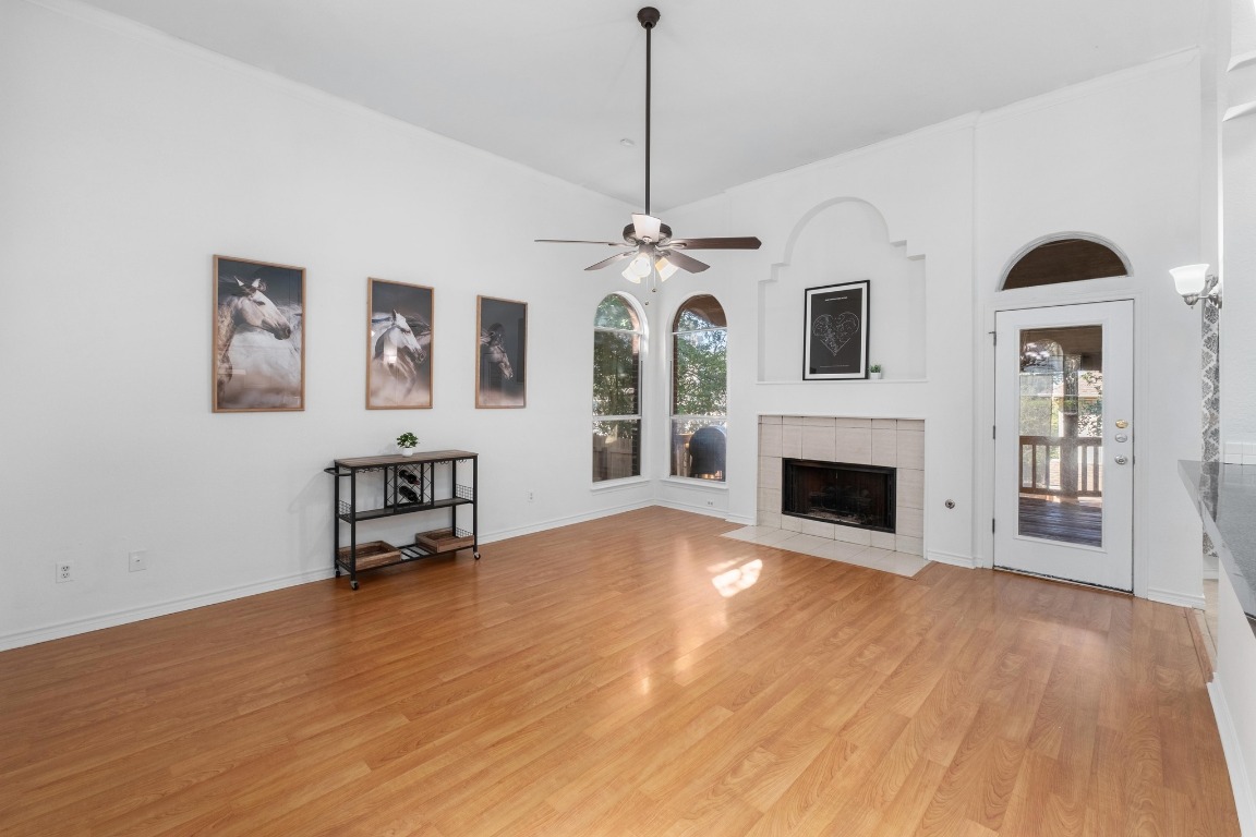 3808 Latimer Drive Austin, TX 78732 - Photo 6 of 31 a view of empty room with fireplace and wooden floor