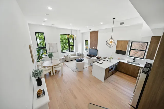 a spacious bedroom with a large bed and a large window