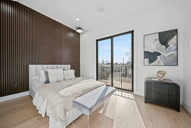 a bedroom with a bed and a painting on the wall