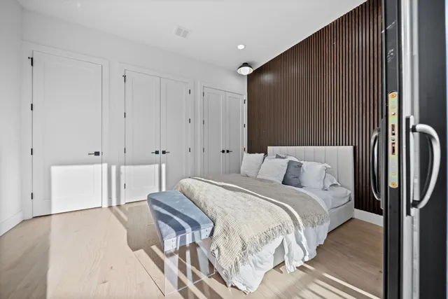 a spacious bedroom with a bed and a chandelier