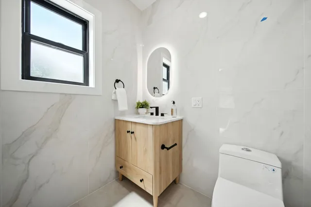 a bathroom with a granite countertop shower and a sink