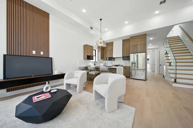 a living room with furniture a rug and white walls