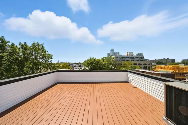 a view of balcony with wooden floor and city view