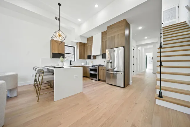 a living room with lots of furniture and a chandelier