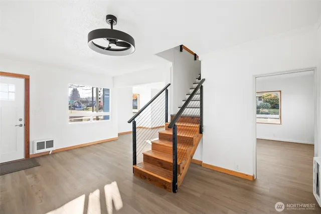 a view of entryway and hall with wooden floor
