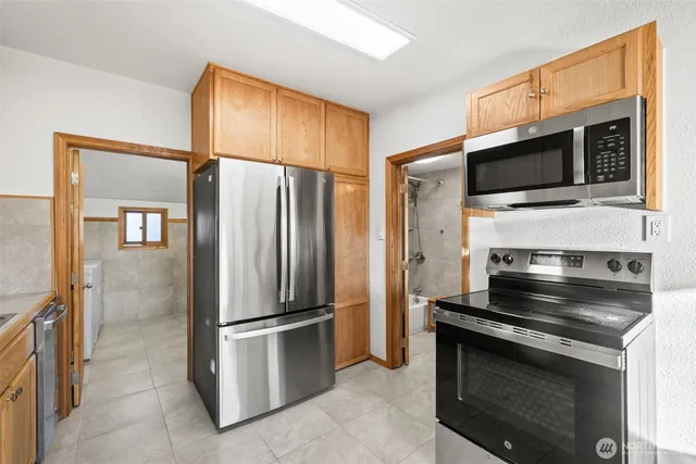 a kitchen with a refrigerator stove and microwave