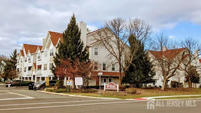 a view of a city street lined with buildings and trees