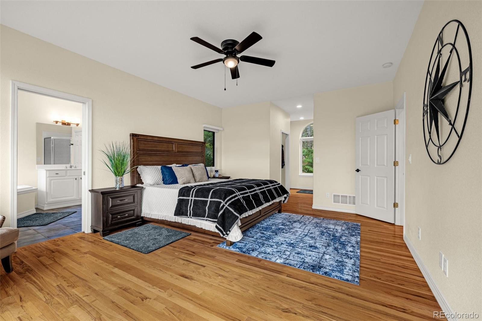 25 Leaming Road Colorado Springs, CO 80906 - Photo 24 of 48 a bedroom with a bed and wooden floor