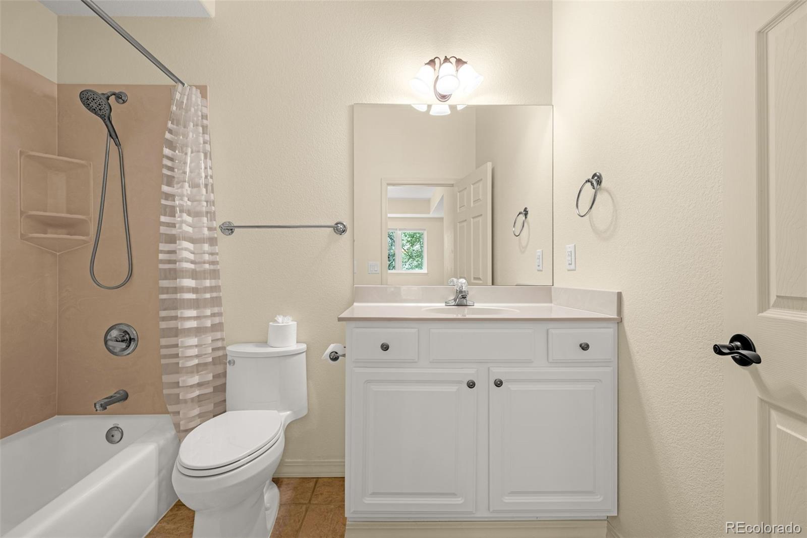 25 Leaming Road Colorado Springs, CO 80906 - Photo 36 of 48 a bathroom with a sink a toilet and shower