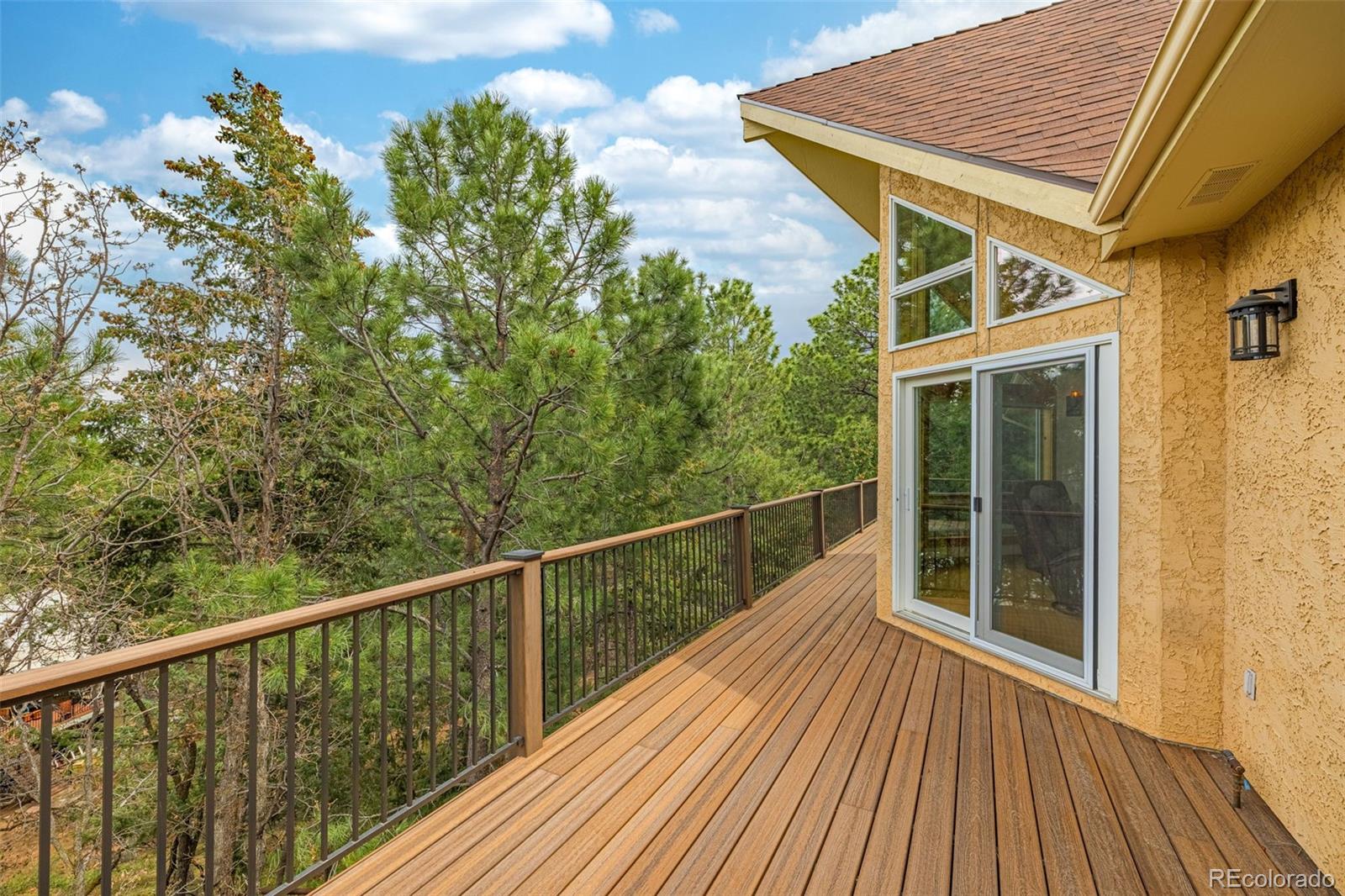 25 Leaming Road Colorado Springs, CO 80906 - Photo 41 of 48 a view of a balcony with wooden floor and fence