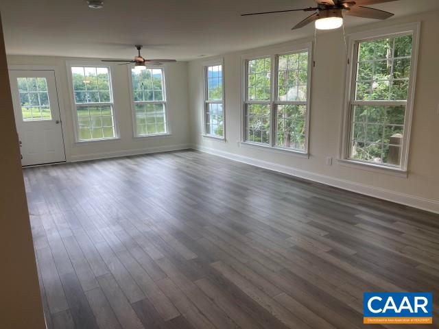 791 Westwood Road Stanardsville, VA 22973 - Photo 13 of 24 an empty room with wooden floor and windows