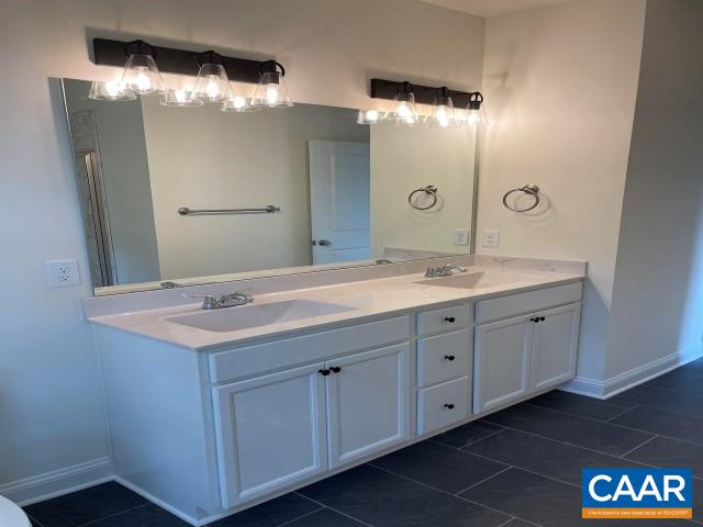 791 Westwood Road Stanardsville, VA 22973 - Photo 15 of 24 a bathroom with a double vanity sink and a mirror